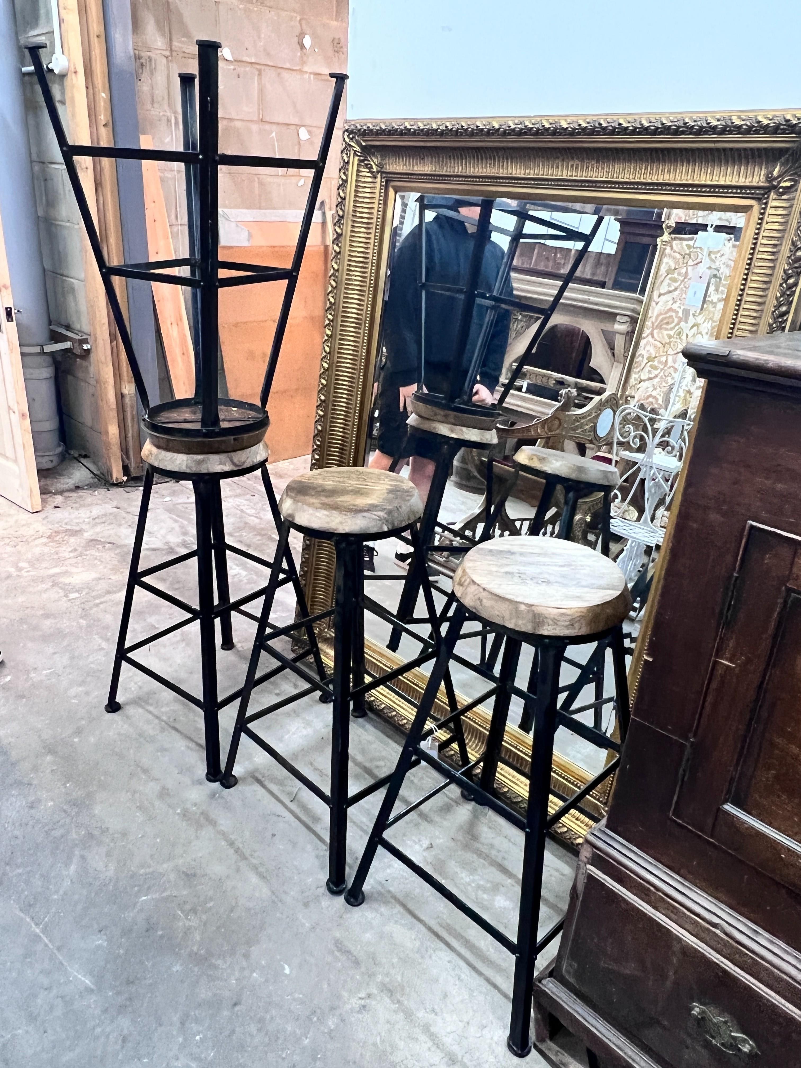 A set of four industrial style painted wrought iron bar stools with circular wooden seats, height 80cm